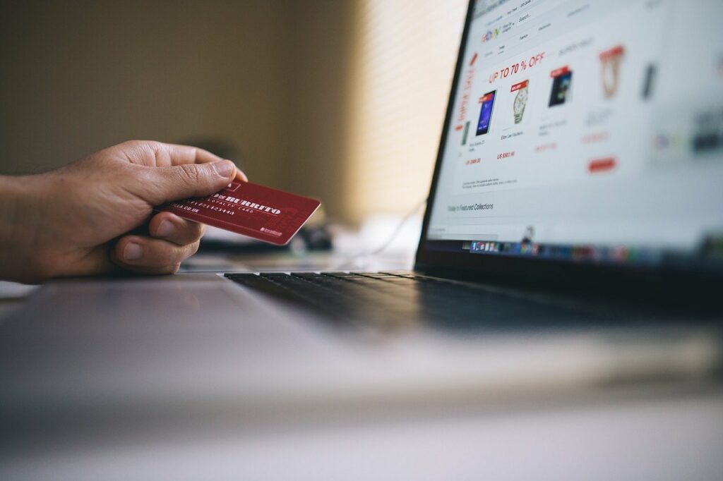 A person shopping online with their credit card