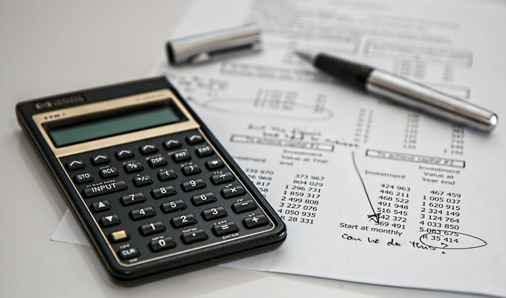 A calculator and a spreadsheet on a table