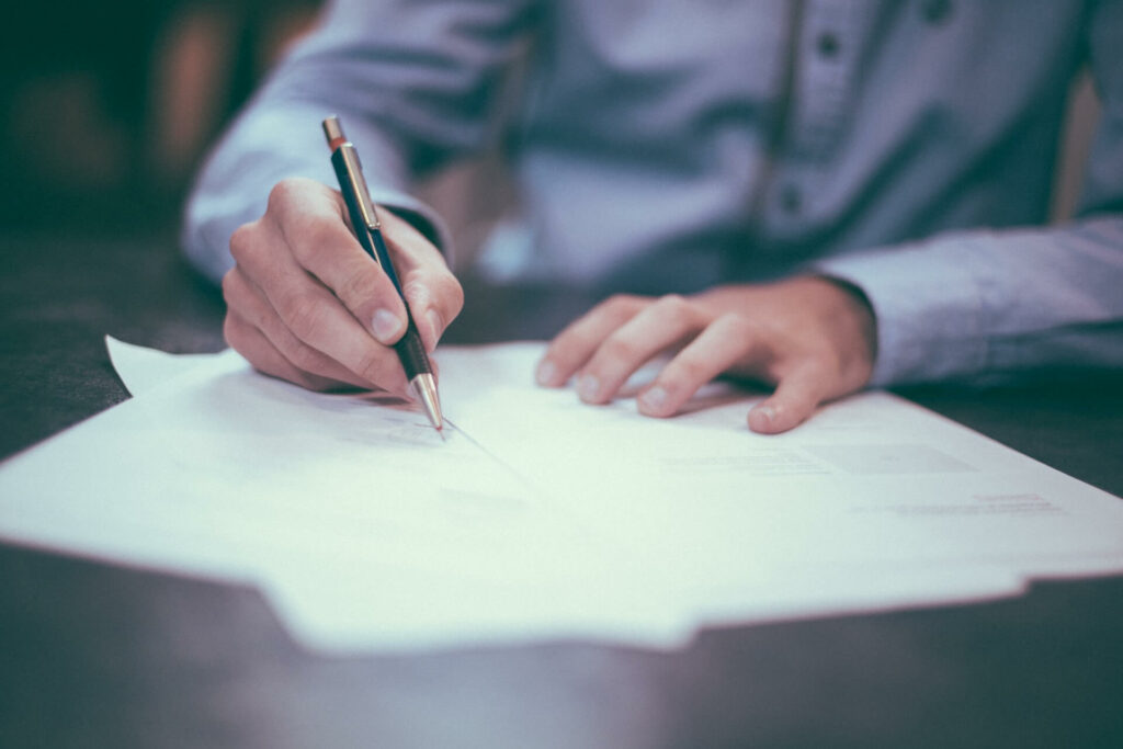 A person signing emergency loan documents